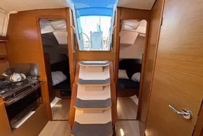Interior of 2020 Jeanneau Sun Odyssey 389 sailboat with wooden finish and compact kitchen.