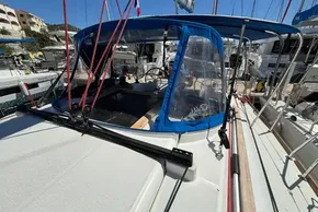 2020 Jeanneau Sun Odyssey 389 sailboat with blue canopy in marina.