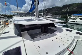 2021 Leopard 45 catamaran docked in a scenic marina with lush hills.