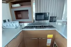 Modern kitchen in 2020 Lagoon 46 yacht with stove, oven, and microwave.