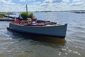 2026 Enkhuizensloep 680 Tender boat on a sunny lake with passengers onboard.