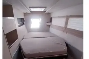 Compact bedroom interior of 2018 Leopard 45 yacht with bed and storage.