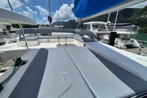 Leopard 45 catamaran deck with seating, docked at marina, mountains in background.