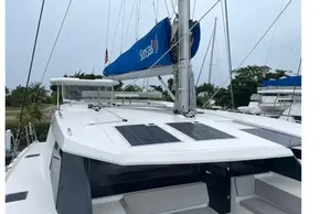 2022 Leopard 45 catamaran with solar panels and blue sail cover, docked in a marina.