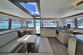 Luxurious interior of a 2021 Leopard 45 catamaran with modern kitchen and seating area.