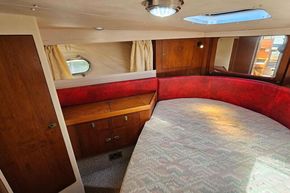 Interior of 1989 Princess 35 Flybridge yacht with cozy cabin and wooden cabinetry.