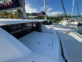 2019 Leopard 40 catamaran docked, featuring spacious deck and sails under clear blue sky.