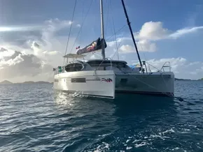 2020 Leopard 40 catamaran sailing on the ocean at sunset.