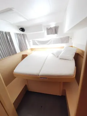 2020 Lagoon 42 yacht interior cabin with bed, modern design, and natural light.