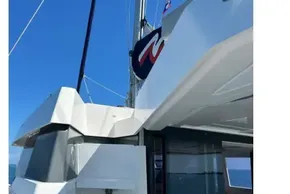 2022 Leopard 42 catamaran, sleek design, sailing on open sea under clear blue sky.
