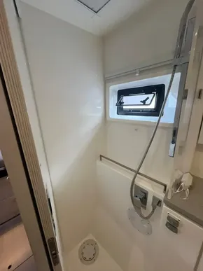 2019 Leopard 45 yacht shower with modern fixtures and window.