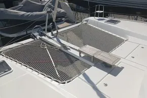 2024 Lagoon 42 catamaran deck with netting and seating, docked in a marina.