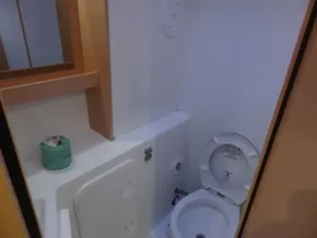 Lagoon 42 2020 model yacht bathroom with toilet and storage cabinet.