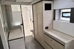 Modern interior of 2021 Leopard 50 yacht bathroom with sleek design and light wood finishes.