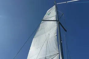 Sail of a 2017 Lagoon 42 catamaran against a clear blue sky.
