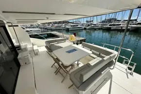 Leopard 53 Powercat 2022 yacht with spacious outdoor seating at marina.