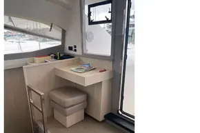 Interior of 2020 Leopard 40 catamaran with modern seating and desk area.
