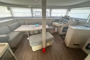 Interior of 2024 Lagoon 42 catamaran with modern seating and navigation area.