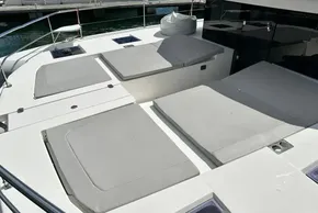 Leopard 53 Powercat 2022 yacht with spacious sunbathing deck and cushioned seating.