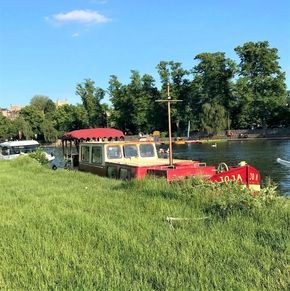 Classic 1927 Dutch Barge moored by the riverside on a sunny day.