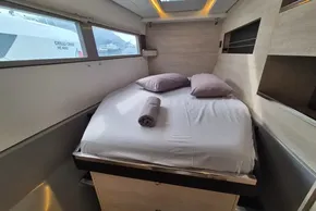 Cozy bedroom interior on a 2020 Leopard 45 yacht with a neatly made bed.