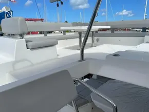 Leopard 50 yacht deck with seating and table, 2020 model, under clear blue sky.