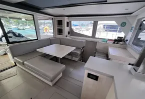 Modern interior of 2019 Leopard 45 catamaran with dining area and large windows.
