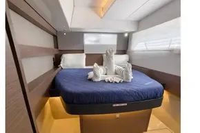 Luxurious bedroom interior of 2021 Leopard 50 yacht with elegant bedding and ambient lighting.