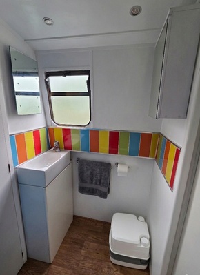 Sink / cupboard showing toilet area and storage cabinetrea