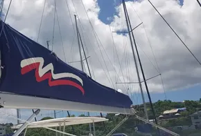 2017 Leopard 48 sailboat with blue sail cover docked under a sunny sky.