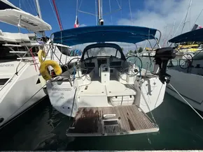 2019 Jeanneau Sun Odyssey 440 docked, featuring a spacious cockpit and blue canopy.
