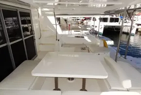 2015 Leopard 51 Powercat yacht with spacious outdoor seating area and table.
