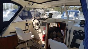 1982 Fairline Mirage 29 Aft Cabin interior with steering wheel and navigation equipment.