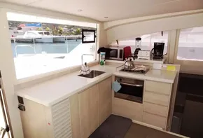 Modern kitchen in 2017 Leopard 43 Powercat yacht with appliances and marina view.