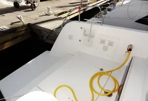 Lagoon 42 catamaran 2020 model docked, showing the stern with yellow power cable.