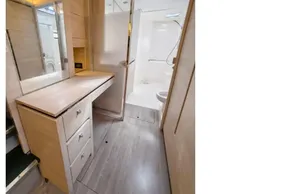 Modern yacht bathroom with wooden cabinetry, mirror, and shower in Leopard 50, 2020 model.