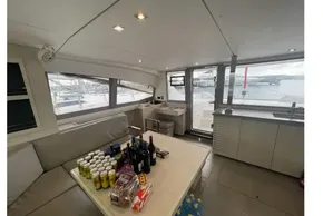 Interior of 2020 Leopard 40 catamaran with stocked table and marina view.