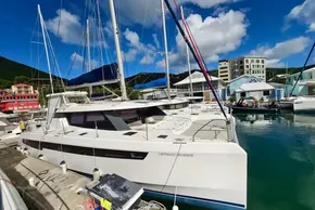 2020 Leopard 45 catamaran docked in a vibrant marina under a clear blue sky.