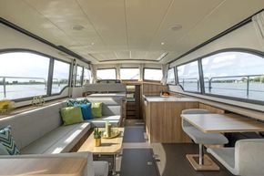 Luxurious interior of 2025 Linssen 45 SL Sedan yacht with modern furnishings and panoramic windows.