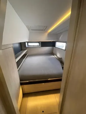 Cozy bedroom interior of 2019 Leopard 45 yacht with modern design and natural lighting.