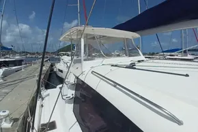2017 Leopard 48 catamaran docked at marina under clear blue sky.
