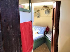 Interior of a classic 1927 Dutch barge with cozy bedroom.