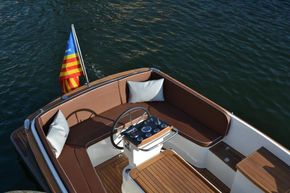 2026 Enkhuizensloep 680 Tender boat with brown seating and flag on calm water.