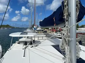 2020 Leopard 50 yacht docked at marina, clear sky, calm waters, sail covered.