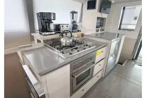 Modern kitchen interior on 2019 Leopard 50 yacht, featuring stainless steel appliances and sleek design.