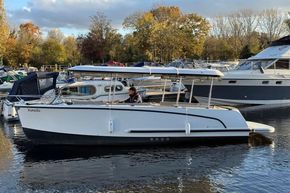 2015 Alfastreet 23 boat on calm water, surrounded by autumn trees and other boats.