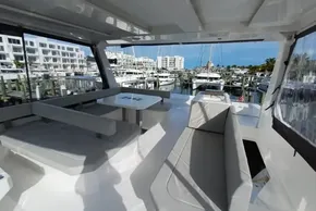 Spacious deck of 2024 Leopard 40 Powercat yacht in marina setting.