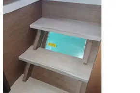 Interior wooden stairs on a 2020 Lagoon 46 catamaran, showcasing modern design.