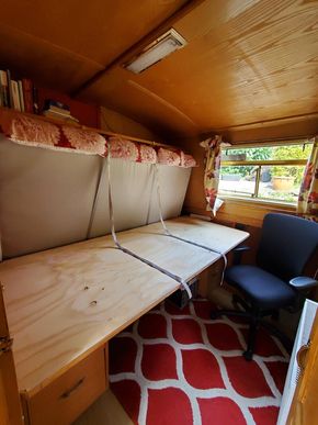 The bed slips down behind the desk and sits on a shelf