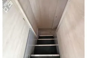 Narrow staircase inside 2019 Leopard 50 yacht, featuring light wood paneling.